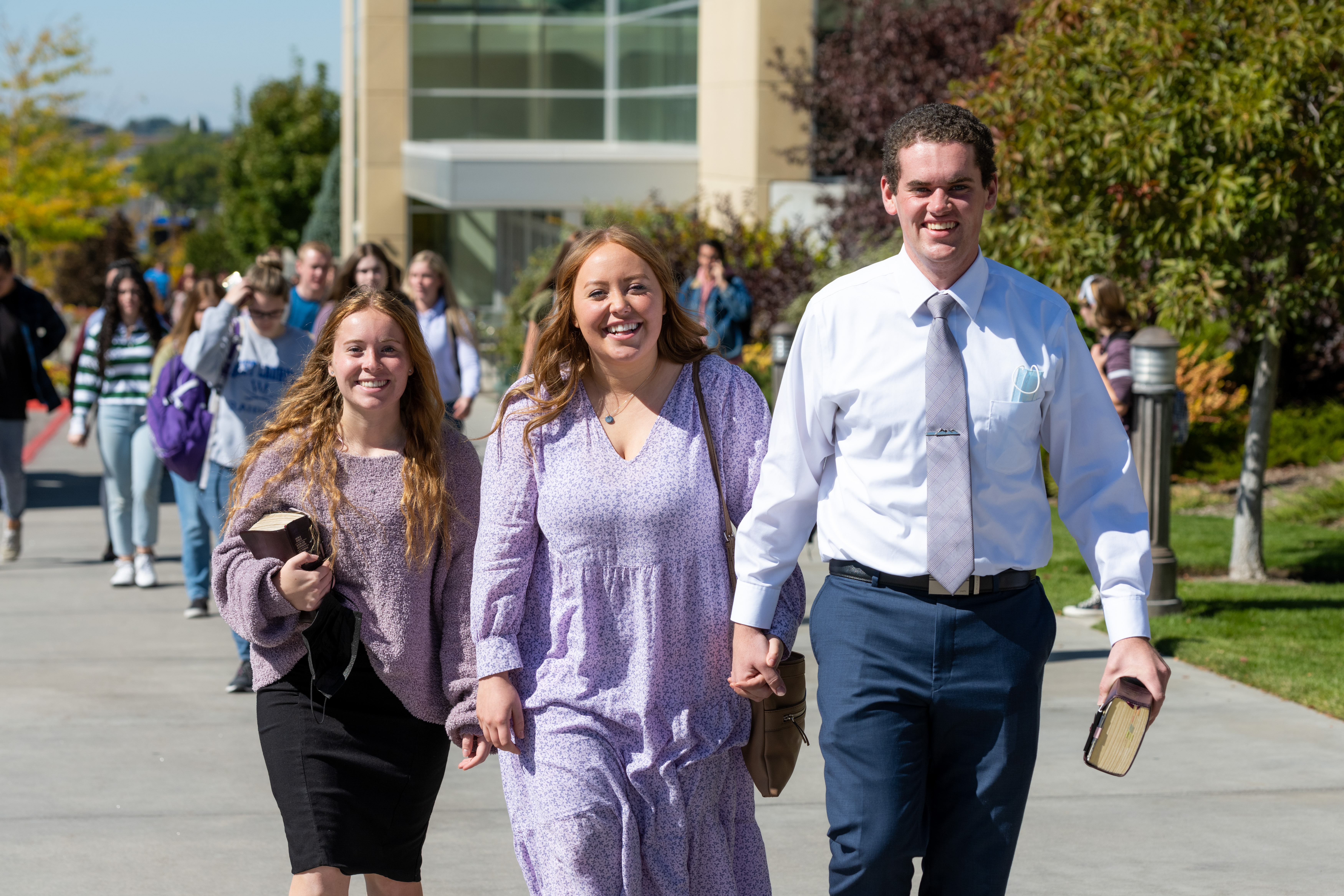 A male student and a female student smile as they exit the BYU-Idaho Center following a devotional.